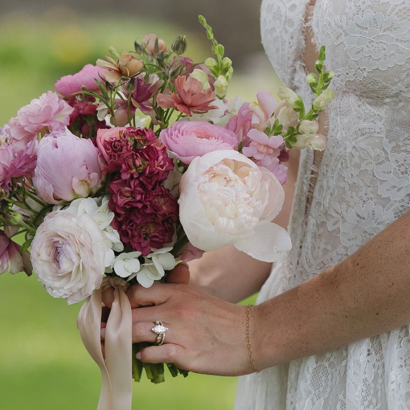 Close-up of a June wedding bouquet with peonies and ranunculus